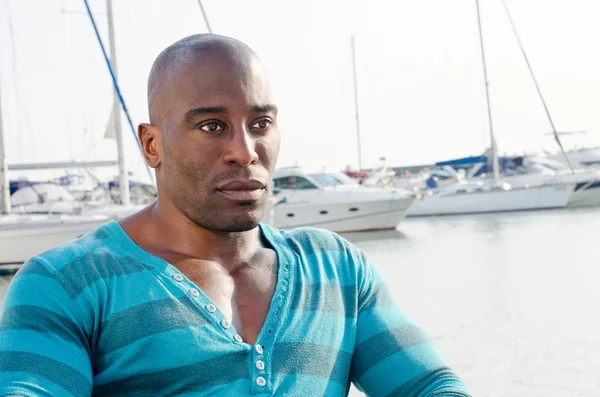 Summer marine scene with a handsome black man. — Stock Photo, Image