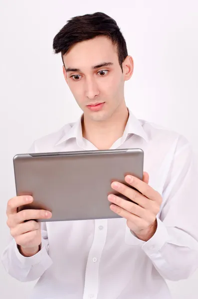 Erstaunter Mann liest von einem Tablet. — Stockfoto