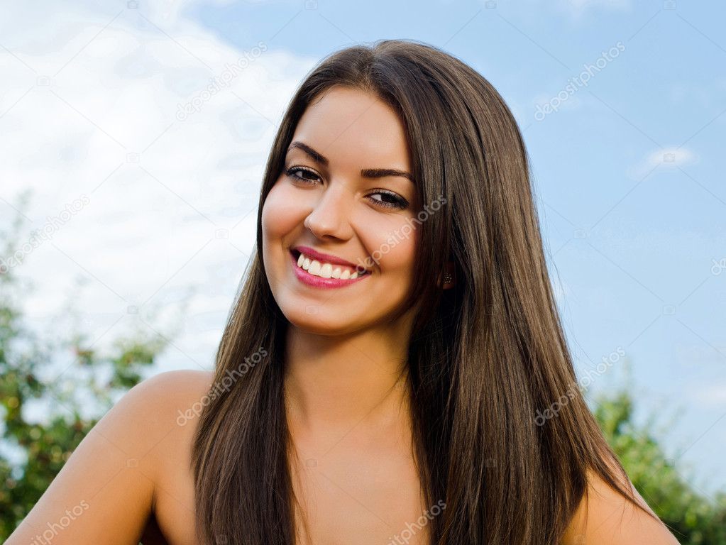 Girl smiling, outdoors.