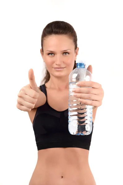 Young fit woman showing thumbs up gesture, with bottle of water in the hands. — Stock Photo, Image