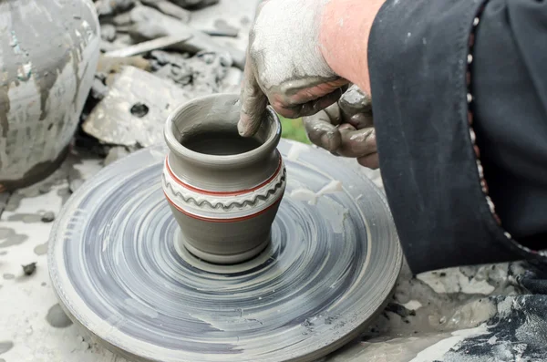 Крупный план рук, делающих керамику из глины на колесе . — стоковое фото