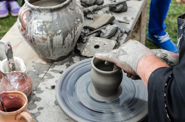 Close-up of hands making pottery from clay on a wheel. — Stock Photo, Image