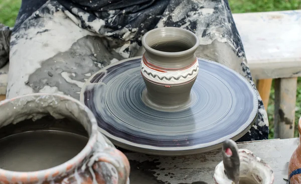 Close-up of hands making pottery from clay on a wheel. — Stock Photo, Image