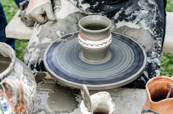 Close-up of hands making pottery from clay on a wheel. — Stock Photo, Image