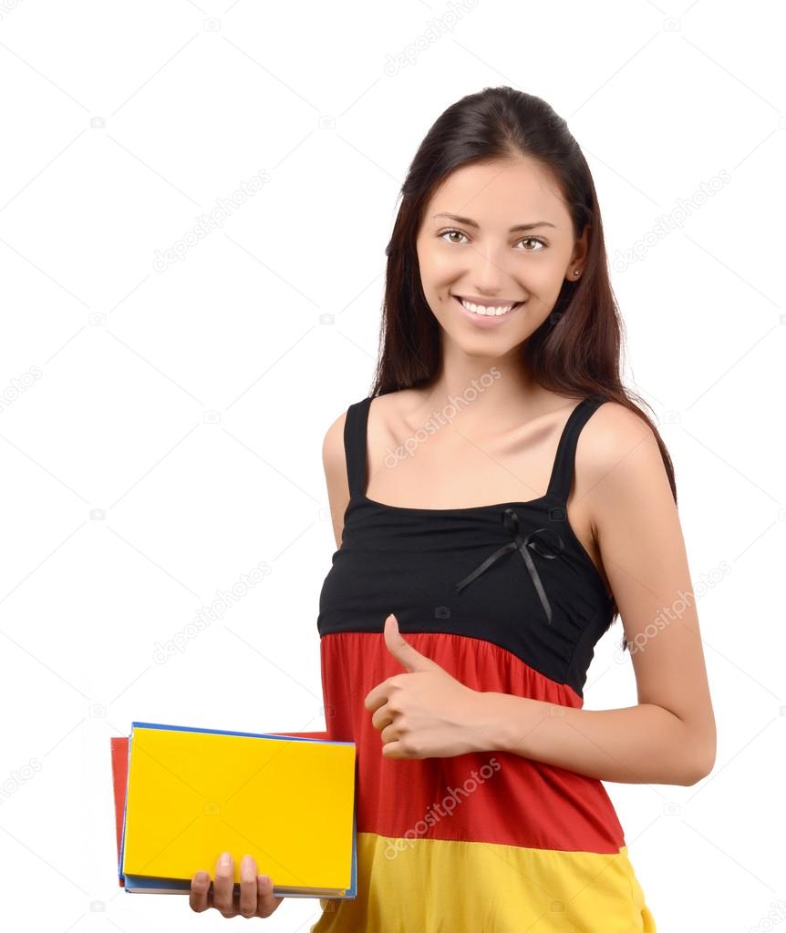 Thumbs up. Beautiful student with Germany flag blouse holding books.