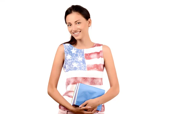 Hermosa estudiante americana con bandera de Estados Unidos en su blusa sosteniendo libros . —  Fotos de Stock