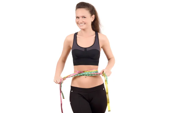 Beautiful fit girl measuring her waist with three measuring tapes. — Stock Photo, Image