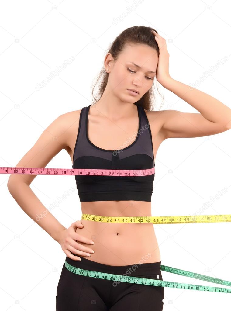 Woman using a tape measure to make bust measurement in inches Stock Photo