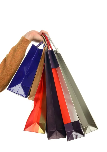 Man hand bedrijf shopping tassen. — Stockfoto