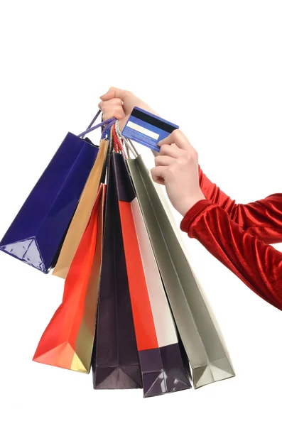 Female hand holding many shopping bags and a credit card. — Stock Photo, Image