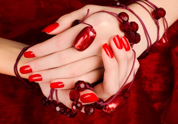 Close up on beautiful female hands with sexy red manicure. — Stock Photo, Image