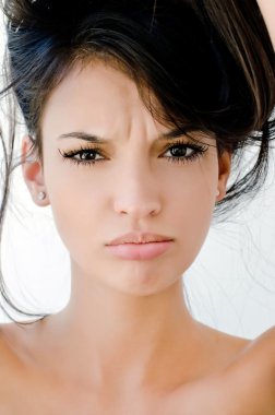 Close up on girl frowning, looking unhappy and stressed. clipart