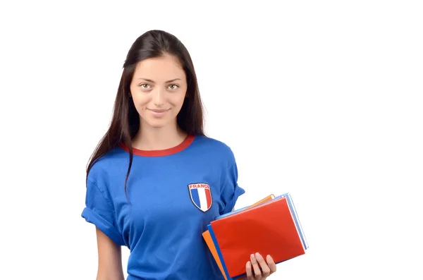 Estudante bonita com bandeira da França na blusa azul segurando livros, livro de capa vermelha em branco . — Fotografia de Stock