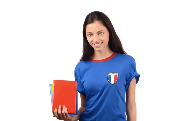 Schöne Studentin mit Frankreich-Fahne auf blauer Bluse mit Büchern, leeres rotes Umschlagbuch. — Stockfoto