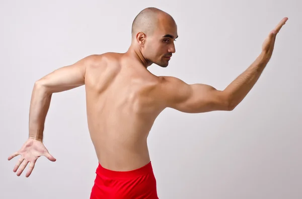 Topless dancer, man stripper posing with his back and arm up. — Stock Photo, Image