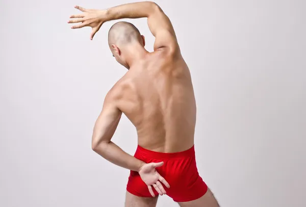 Topless man in underwear posing with his back. Fit dancer training. Stripper dancing. — Stock Photo, Image