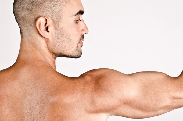 Close up on profile of a man and the arm with the shoulder and biceps. — Stock Photo, Image