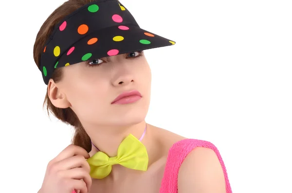 Girl wearing a colorful polka dotted visor hat and a neon green bowtie. — Stock Photo, Image