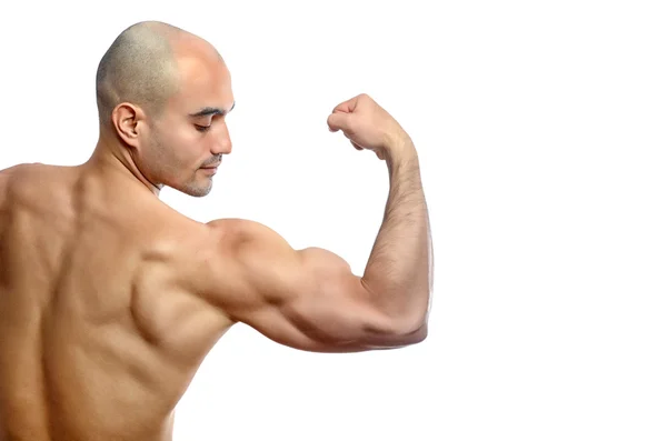 Strong bald bodybuilder man flexing his muscles showing his perfect biceps, triceps and back. — Stock Photo, Image