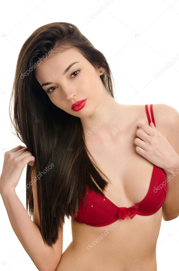 Sexy woman with long beautiful hair wearing a red bra. Attractive girl with a sexy cleavage.