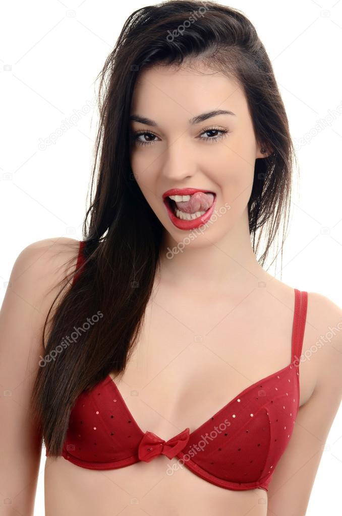 Sexy woman in red bra being sexy with her tongue out. Attractive girl with a sexy cleavage.