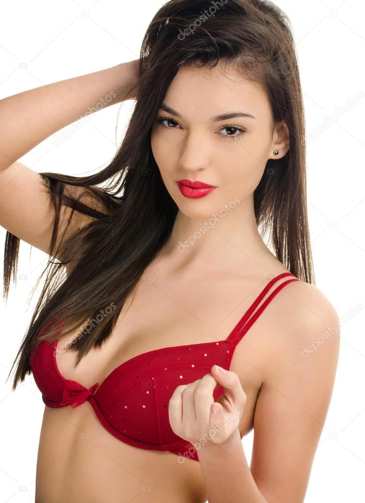 Sexy woman in red bra attracting you with the finger. Seductive girl with a sexy cleavage.