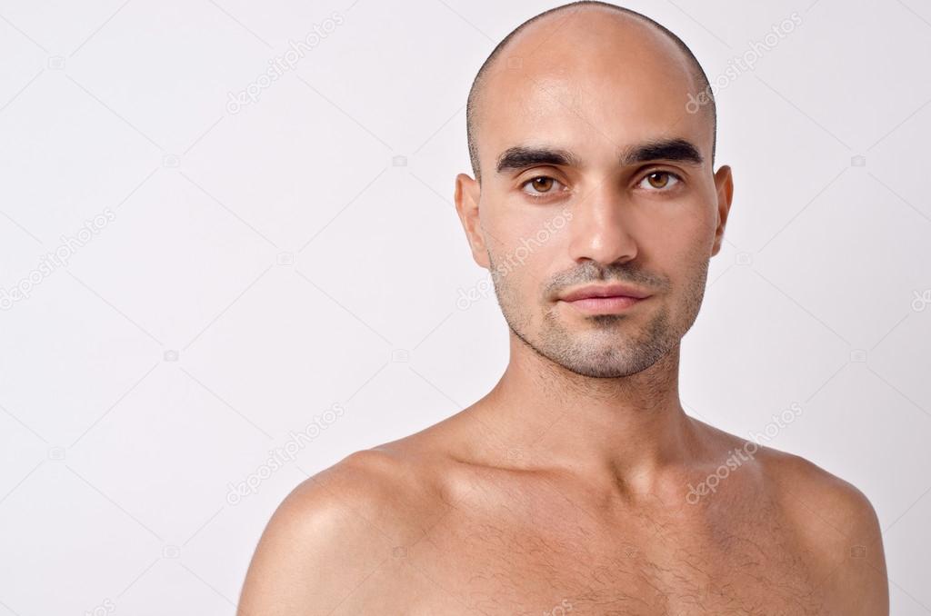 Portrait of a bald man. Bald Caucasian handsome man with topless shoulders.