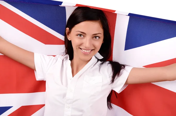 Retrato de uma bela menina britânica sorrindo segurando a bandeira do Reino Unido . — Fotografia de Stock