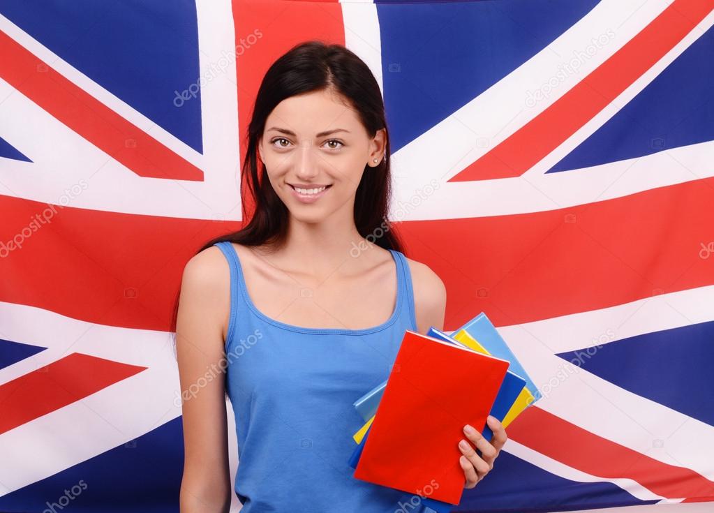 Learn English. Beautiful student holding books, red blank book cover.