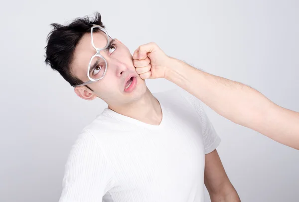Young man getting punched in the jaw. — Stock Photo, Image