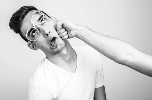 Young man getting punched in the jaw.