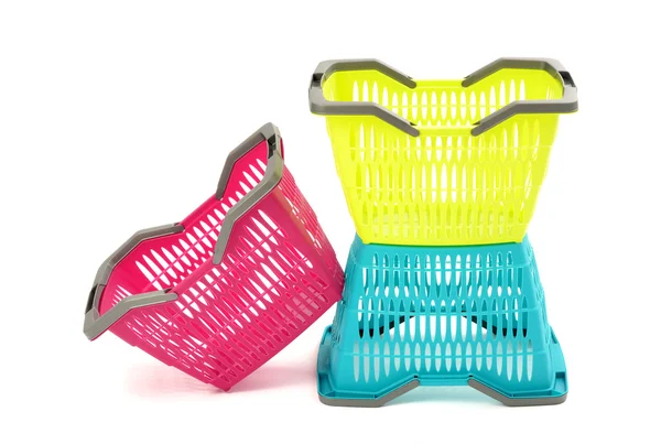 Blue, yellow and pink plastic shopping basket isolated on white. — Stock Photo, Image