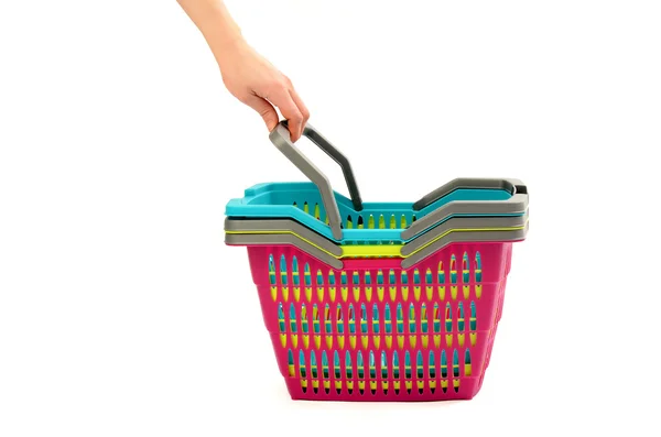 Mão alcançando para tirar uma cesta de compras de uma pilha . — Fotografia de Stock