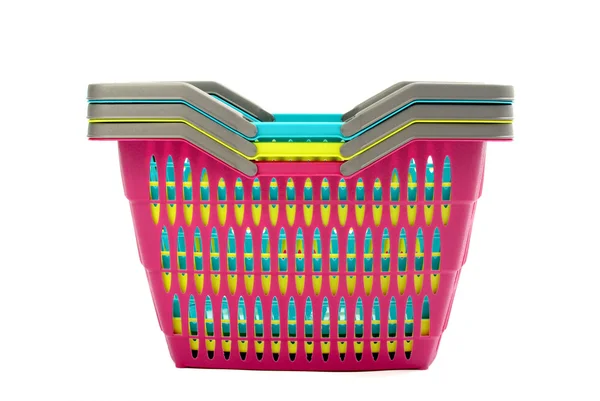 Pile of colorful plastic shopping baskets isolated on white. — Stock Photo, Image