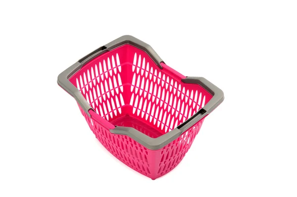 Cesta de compras de plástico rosa isolado no branco . — Fotografia de Stock