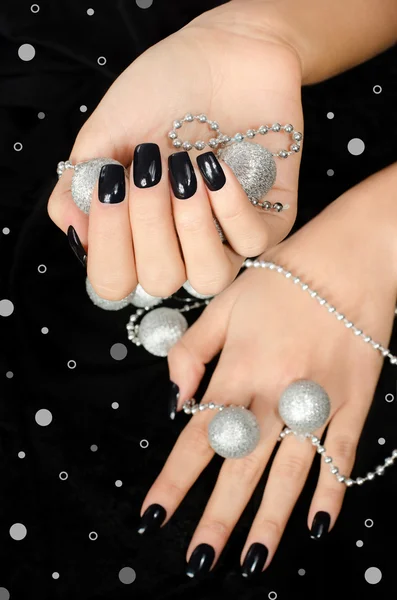 Close up on beautiful female hand with black manicure. — Stock Photo, Image