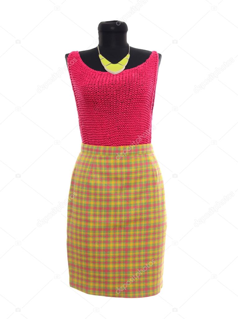 Pink blouse and neon yellow plaid skirt on mannequin.