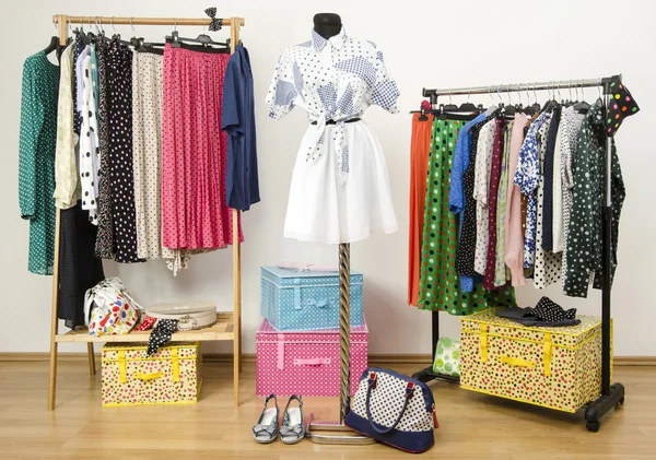 Dressing closet with polka dots clothes arranged on hangers and an outfit on a mannequin. — Stock Photo, Image