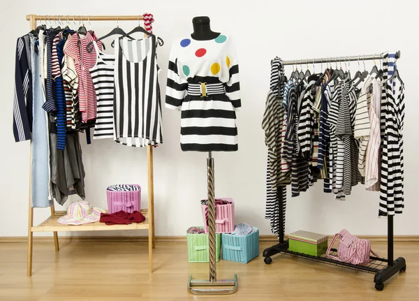 Dressing closet with striped clothes arranged on hangers. Outfit with stripes and polka dots on a mannequin. — Stock Photo, Image