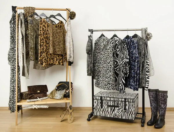 Dressing closet with animal print clothes arranged on hangers and accessories. — Stock Photo, Image