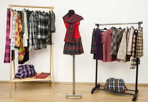 Dressing closet with plaid clothes arranged on hangers and an outfit on a mannequin. — Stock Photo, Image