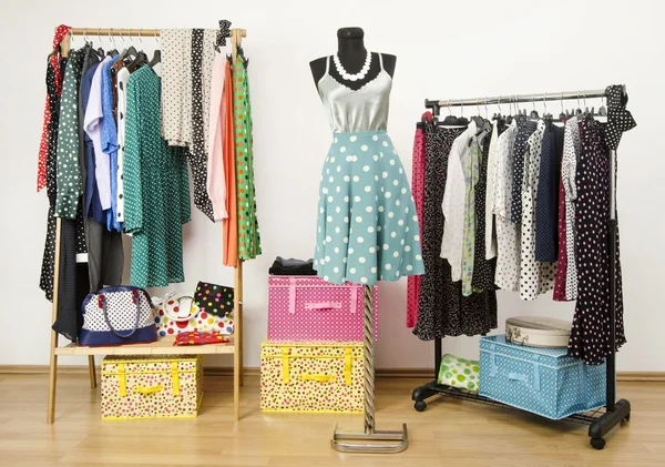 Dressing closet with polka dots clothes arranged on hangers and an outfit on a mannequin. — Stock Photo, Image