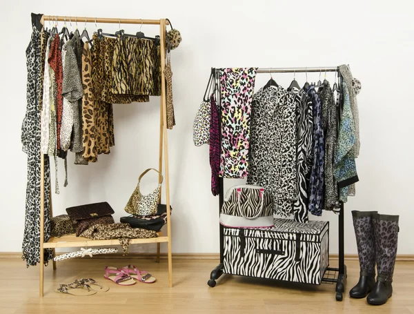 Dressing closet with animal print clothes arranged on hangers. — Stock Photo, Image