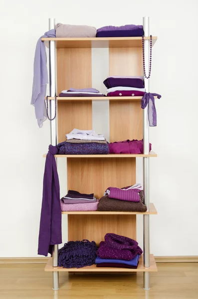 Purple clothes nicely arranged on a shelf. — Stock Photo, Image