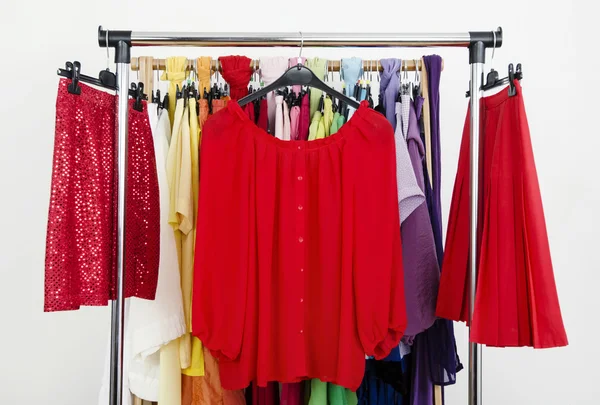 Cute red outfits displayed on a rack. — Stock Photo, Image