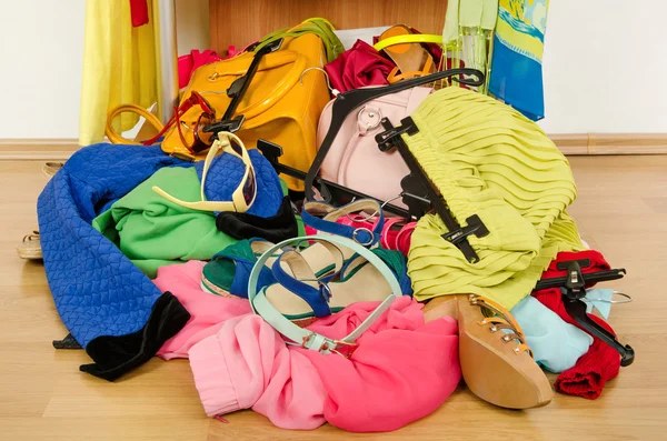 Close up on a big pile of clothes and accessories thrown on the ground. — Stock Photo, Image