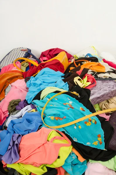 Close up on a big pile of clothes and accessories thrown on the ground. — Stock Photo, Image