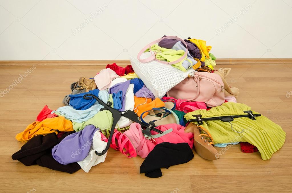 Close up on a big pile of clothes and accessories thrown on the ground.