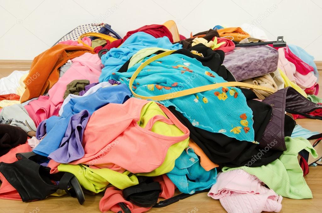 Close up on a big pile of clothes and accessories thrown on the ground.