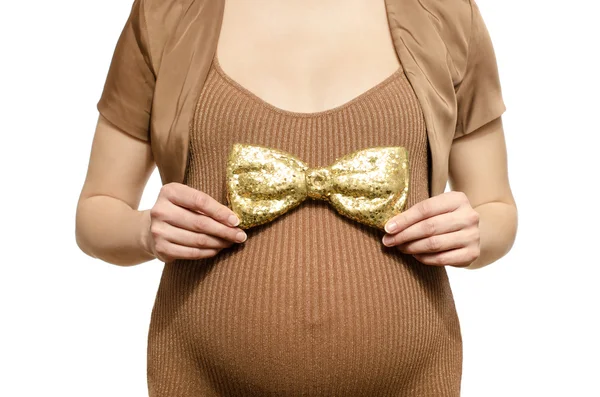 Woman expecting a baby boy holding a big gold bowtie. — Stock Photo, Image